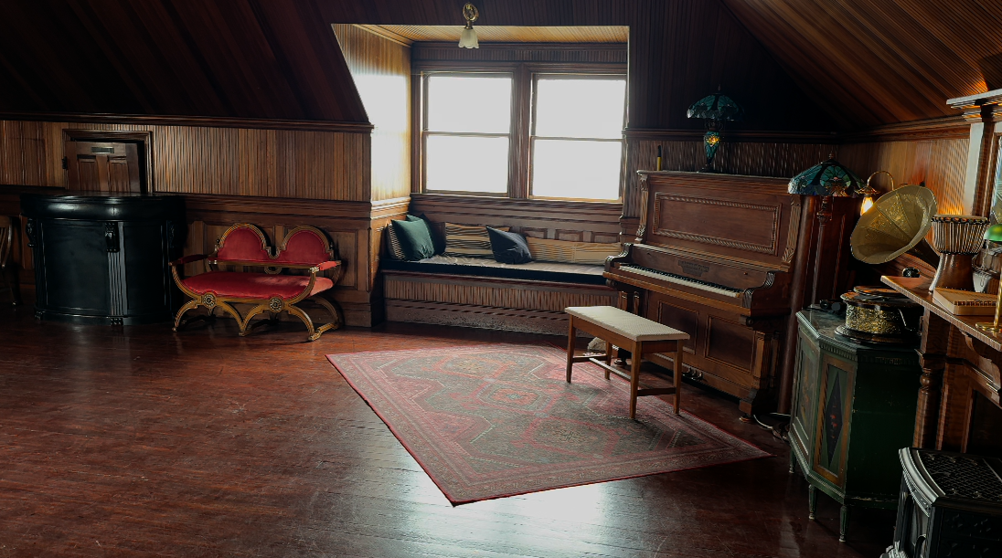 Weller House third-floor ballroom with piano and window seat