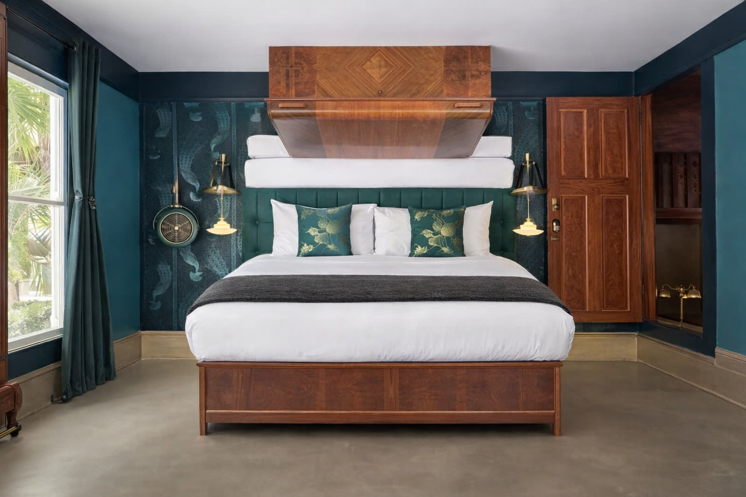 Weller House bedroom with green velvet headboard and wood canopy