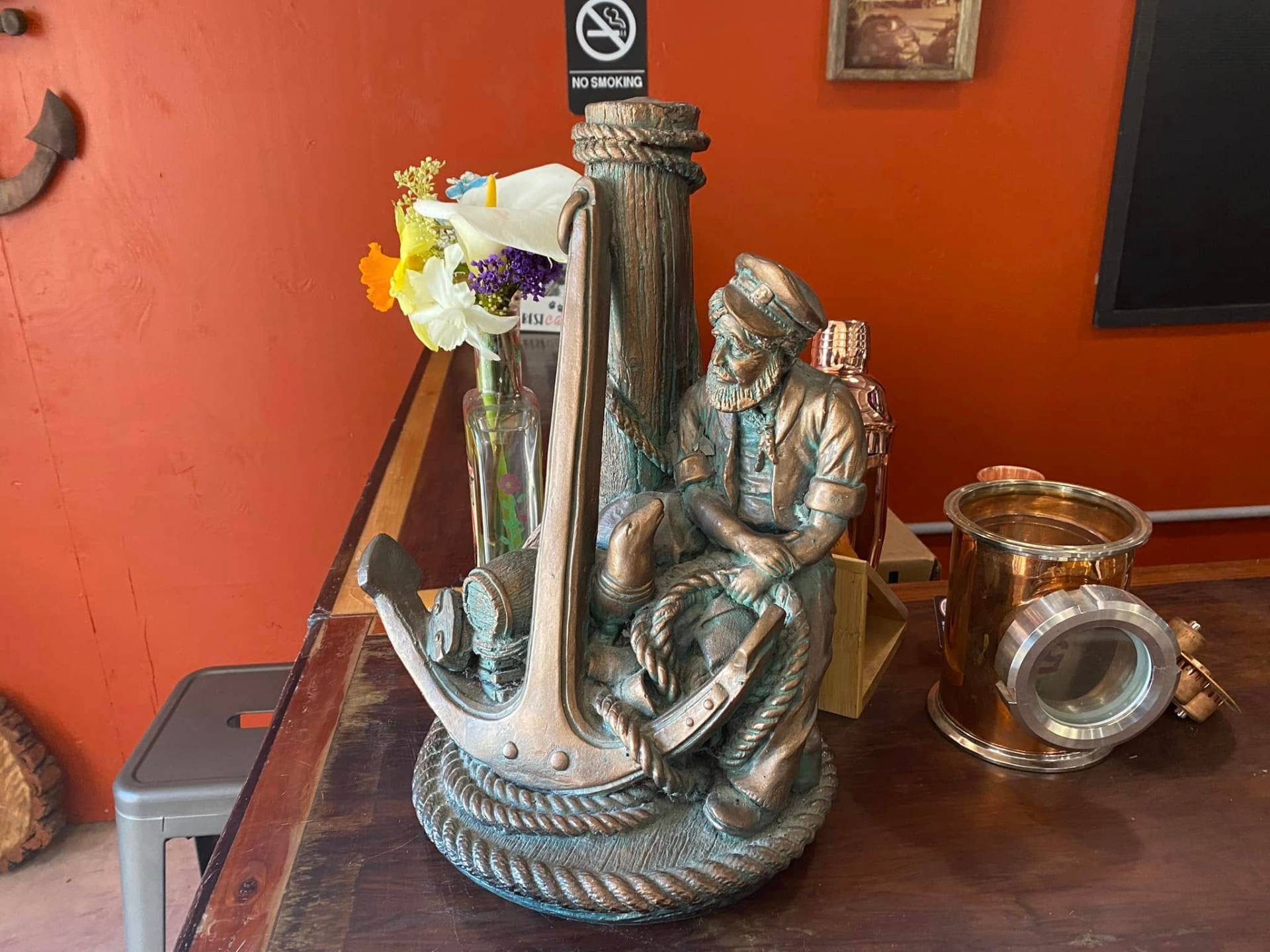 Bronze sailor and anchor statue inside Schnaubelt Distillery